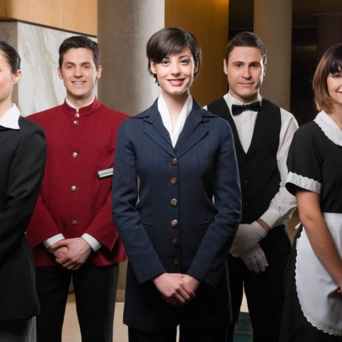 B62PW9 Hotel staff standing together and smiling